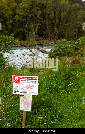 A warning sign that poisoned Possum baits are being used in the area in close proximity to a river. Stock Photo