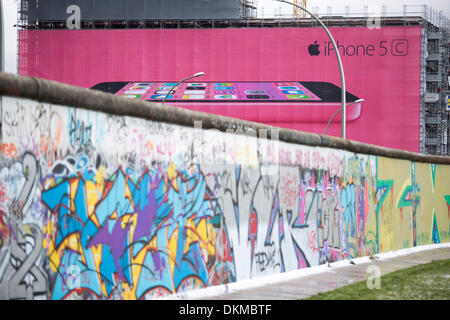 06/12/2013  Apple iPhone 5C billboard on the side of a building site behind the Berlin Wall. Stock Photo