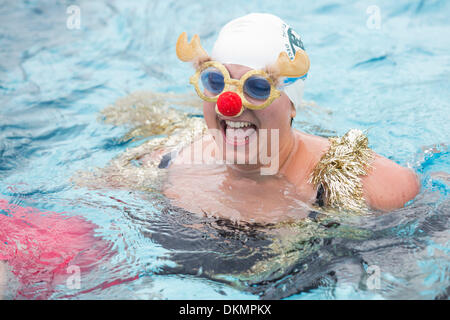 London, UK. 7 December 2013. Woman with tinsel and red nose reindeer glasses. Several hundred brave swimmers, many in seasonal fancy dress, braced the cold (water temperature 6°C, air temperature 9°C) and took a plunge at the Outdoor Swimming Society's annual December Dip at the Parliament Hill Lido on North London's Hampstead Heath. Photo. Nick Savage/Alamy Live News Stock Photo