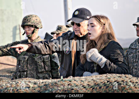 US Vice President Joe Biden points out an area of North Korea to his granddaughter Finnegan Biden at Observation Point Ouellette December 7, 2013 near Wonju, South Korea. Stock Photo