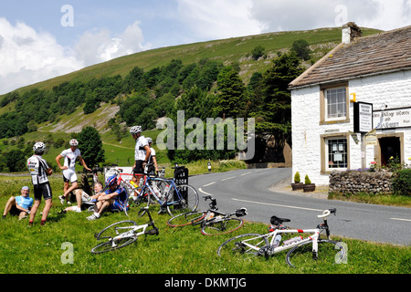 Cyclists enjoying a break in Buckden, Upper Wharfedale, Yorkshire Dales, England Stock Photo