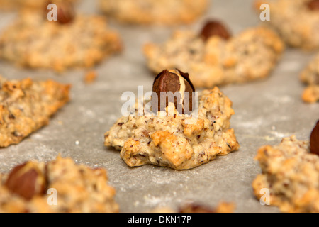 christmas cookies, macaroons with hazelnuts on baking paper Stock Photo