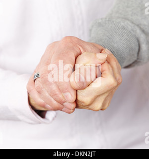 Happy senior citizen couple holding their hands together Stock Photo