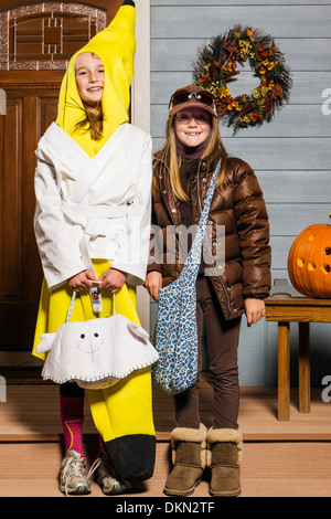 Young children dressed in costume for Halloween Trick-or-Treating Stock Photo