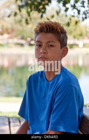 Trendy fashionable 11-13 year old Hispanic boy outside  multi racial diversity racially diverse multicultural cultural United States MR Stock Photo