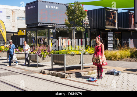 Busker at the Christchurch Container Mall, Christchurch, New Zealand. The Container, or Re:Start, Mall was built from shipping.. Stock Photo