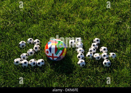 Message for 2014 featuring international teams football soccer balls in green grass field Stock Photo