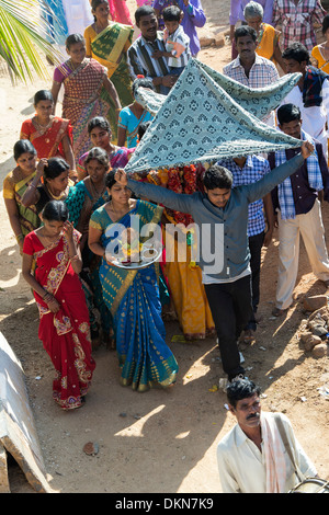 Hindu marriage procession through a rural indian village . Andhra Pradesh, India Stock Photo