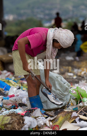 A child scavenging for anything of value within the Inayawan Landfill waste site,Cebu City,Philippines Stock Photo