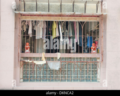Fenced-in balcony used as extra room in the densely populated city centre of Macau (Macao), SAR of China Stock Photo