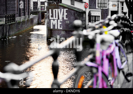 Love me graffiti on the wall of a waterway canal in Amsterdam Stock Photo