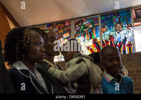 Soweto, South Afica. 8th Dec 2013.  Members of the Regina Mundi Church hold a church service to honour former President Nelson Mandela on December 8, 2013 in Soweto, South Africa. The Father of the Nation, Nelson Mandela, Tata Madiba, passed away quietly on the evening of December 5, 2013 at his home in Houghton with family. He will be buried in Qunu on 15 December 2013. Credit:  Gallo images/Alamy Live News Stock Photo