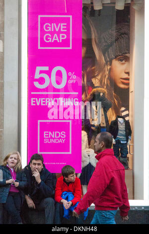 London, UK. 8th Dec 2013. Thousands of shoppers laden with bags throng London's Oxford Street as retailers mark down prices in a bid to increase sales ahead of Christmas. Credit:  Paul Davey/Alamy Live News Stock Photo