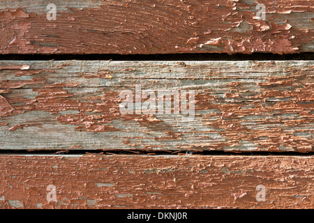 Background of an old timber boards with skinning red or brownish paint. Stock Photo