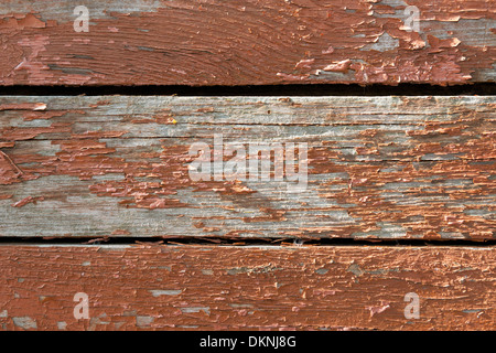 Background of an old timber boards with skinning red or brownish paint. Stock Photo