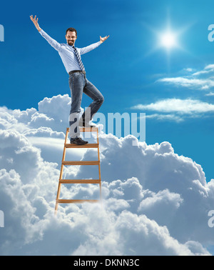 Young confident businessman standing at the ladder high in the sky spread his arms Stock Photo