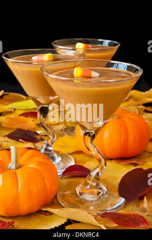 Martini glasses filled with butterscotch pudding decorated with candy corn Stock Photo