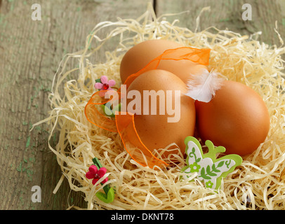 Easter eggs in nest on a wooden background Stock Photo