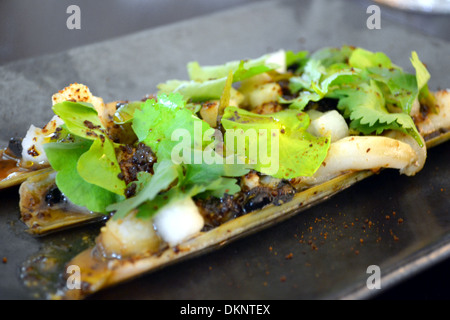 STEAMED RAZOR CLAMS, SALTED BLACK BEANS & PICKLED CHILLI Stock Photo