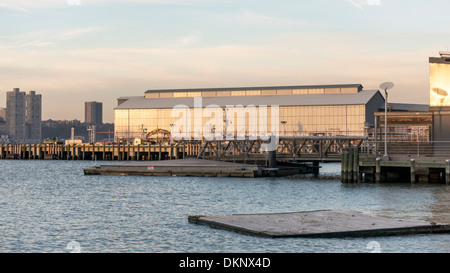 New York City Department of Sanitation pier at twilight with new pier construction in foreground on Hudson River waterfront Stock Photo