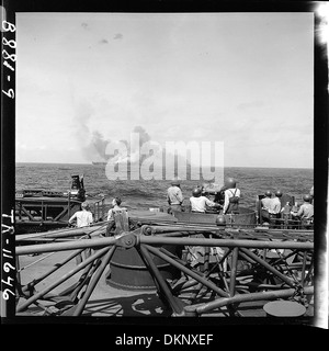 USS Intrepid (CV-11) after being hit by Japanese plane in suicide dive in the Pacific. Taken from USS New Jersey... 520885 Stock Photo