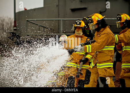 U.S. Air Force fire protection specialists from the New Jersey Air National Guard's 177th Fighter Wing fight a fire during a training exercise at the Military Sealift Command Training Center East in Freehold, N.J. on Dec. 5. The facility, which is one of Stock Photo