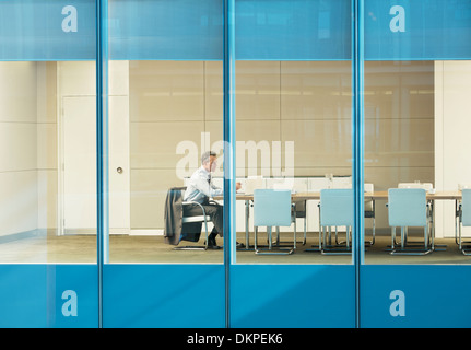 Businessman sitting in conference room Stock Photo