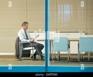 Businesswoman working at conference table Stock Photo