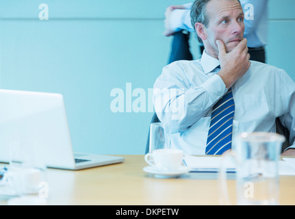 Businessman sitting in meeting Stock Photo