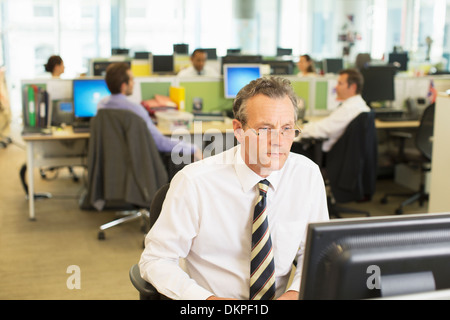 Businessman working at computer in office Stock Photo