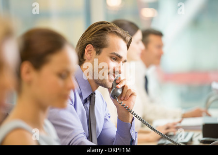 Businessman talking on telephone in office Stock Photo