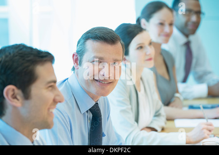 Businessman smiling in meeting Stock Photo