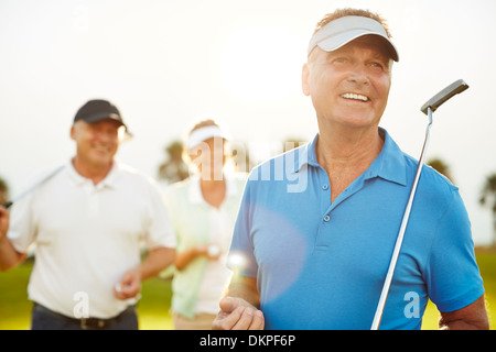 Senior adults on golf course Stock Photo