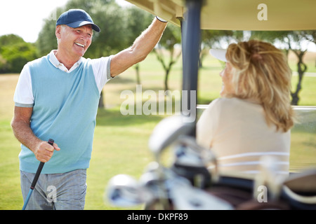 Senior couple in golf cart Stock Photo