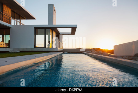 Lap pool outside modern house at sunset Stock Photo
