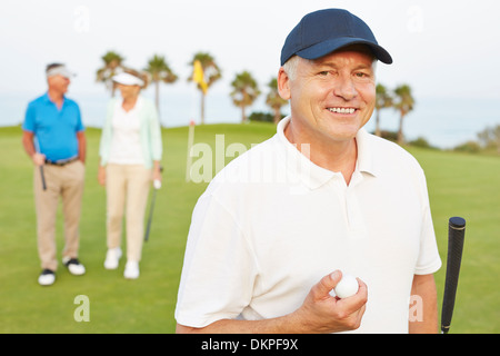 Smiling senior man on golf course Stock Photo