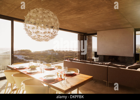Modern dining room and living room overlooking ocean Stock Photo