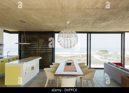 Dining room and kitchen overlooking ocean Stock Photo
