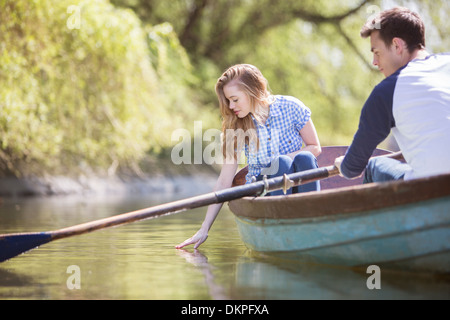 Couple in rowboat on river Stock Photo