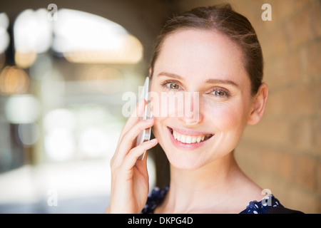 Woman talking on cell phone outdoors Stock Photo