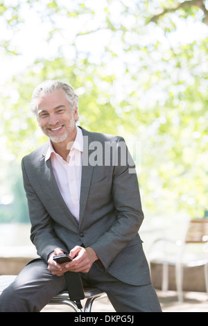 Businessman smiling outdoors Stock Photo