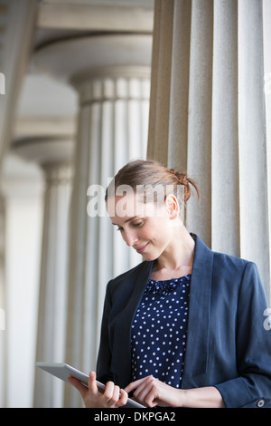 Businesswoman using digital tablet outdoors Stock Photo