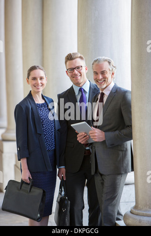 Business people smiling outdoors Stock Photo