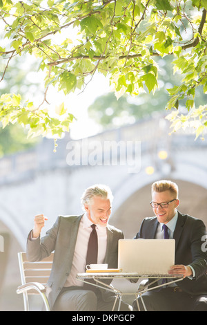 Businessmen working at sidewalk cafe Stock Photo