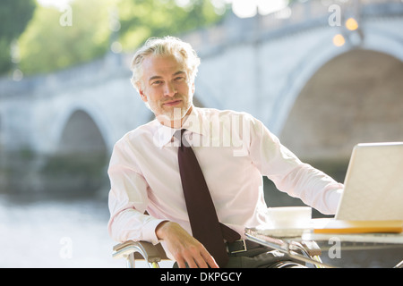 Businessman working at sidewalk cafe Stock Photo