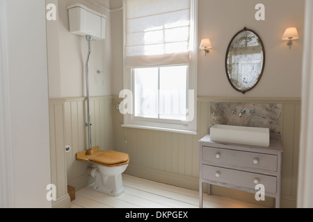 Toilet and sink in ornate bathroom Stock Photo