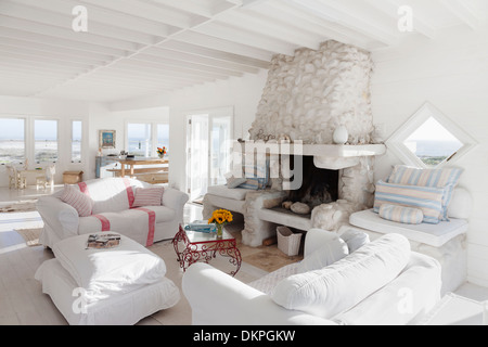 Sofas and fireplace in white living room Stock Photo