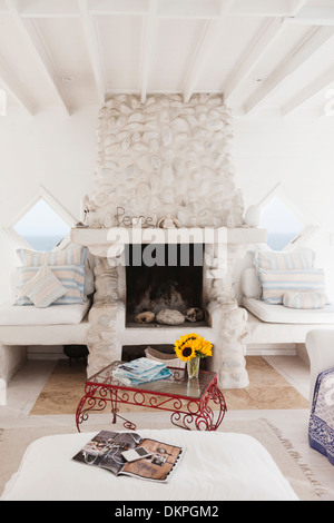 Coffee table and fireplace in white living room Stock Photo