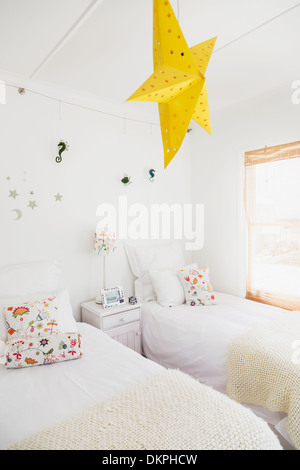Yellow star lamp and wall decorations in childrens bedroom Stock Photo