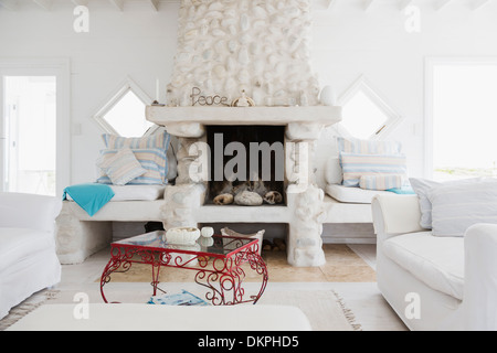 Decorations on fireplace in white living room Stock Photo